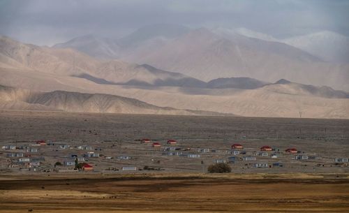 Scenic view of land and mountains against sky