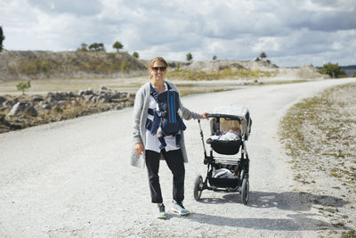 Smiling woman with pram