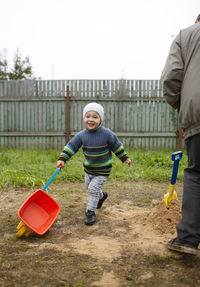 Full length portrait of cute playing at yard