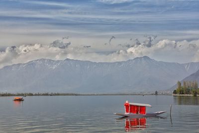 Scenic view of lake and mountains against sky