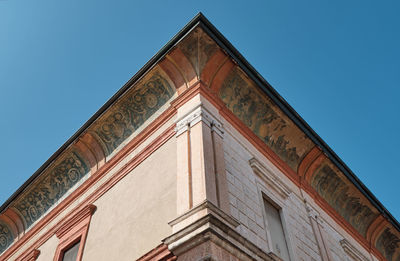 Low angle view of old building against clear blue sky