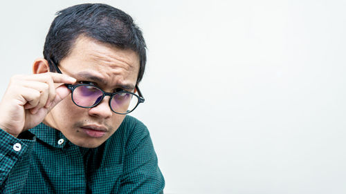 Portrait of young man against white background