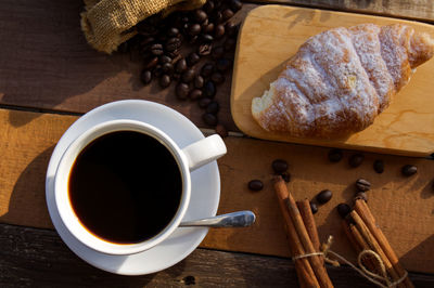 High angle view of coffee and cup on table