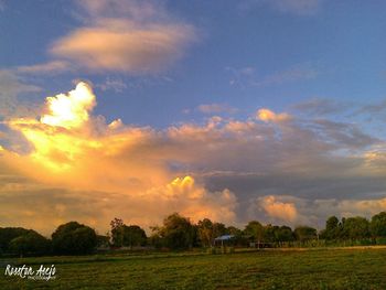 Scenic view of field against sky during sunset