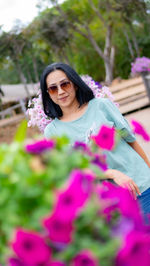 Portrait of a smiling young woman with pink flower