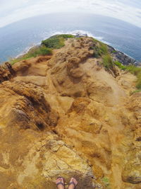 High angle view of rocks on shore against sky