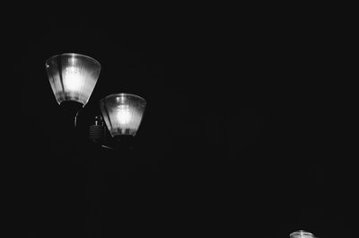 Low angle view of illuminated lamp post at night