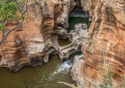 Low angle view of rock formations in water