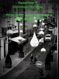 People walking on illuminated street in city