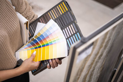 Cropped hand of woman holding shopping bags