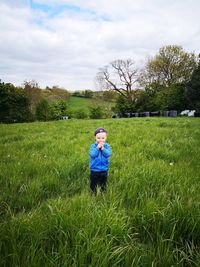 Man standing on field against sky