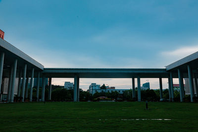 Buildings on field against sky