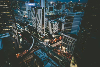 High angle view of illuminated buildings in city at night