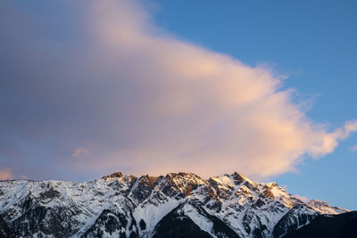 The sun sets on iconic mount currie still covered in snow on a spring day in the coast mountains of british columbia.