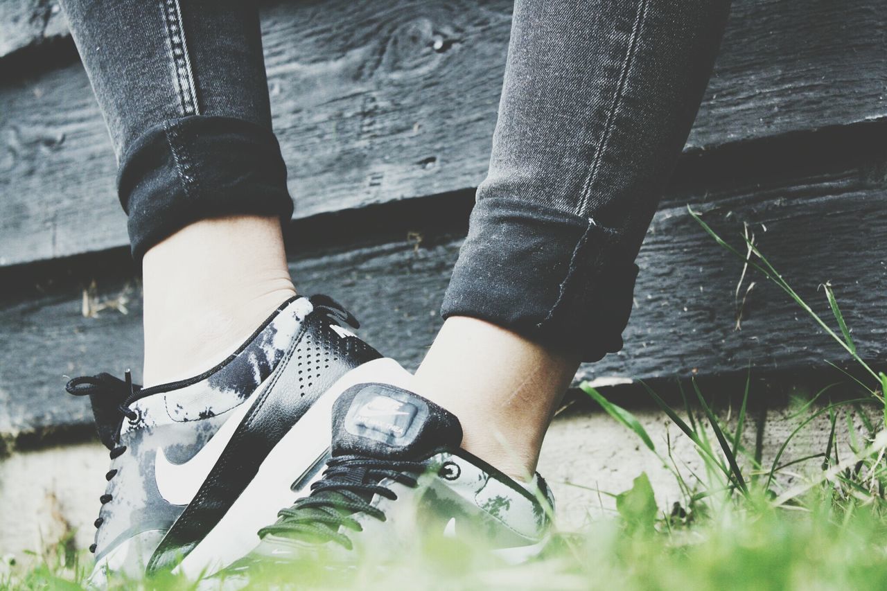 low section, person, shoe, lifestyles, leisure activity, standing, water, part of, human foot, high angle view, footwear, personal perspective, outdoors, grass, men, day