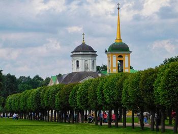 People at temple against sky
