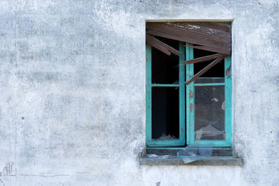 Low angle view of window on wall of building