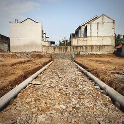 Railroad track amidst buildings against sky