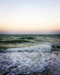 Scenic view of sea against clear sky during sunset