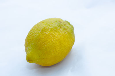 Close-up of lemon against white background