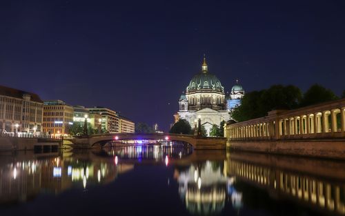 Reflection of illuminated buildings in city at night