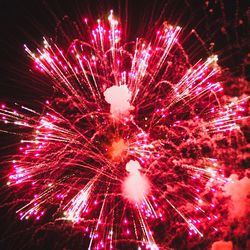 Low angle view of firework display at night