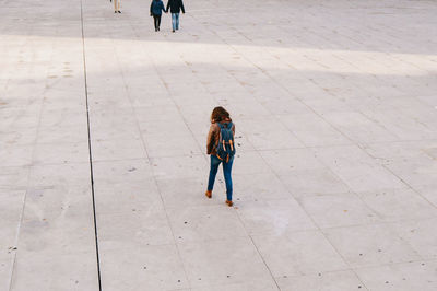 Full length rear view of woman walking outdoors