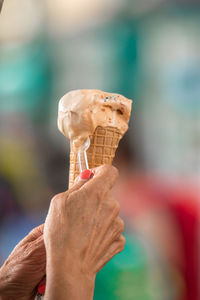 Cropped hand holding ice cream