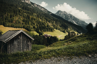 Scenic view of trees and houses against sky