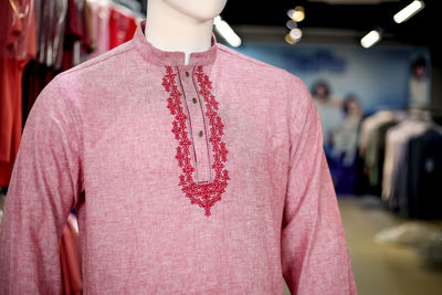 Close-up of pink kurta on mannequin in store