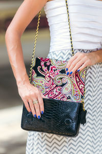 Girl holding a bag made of handmade python skin