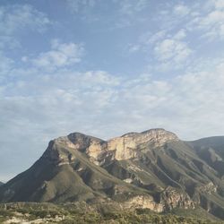 Scenic view of mountain against cloudy sky