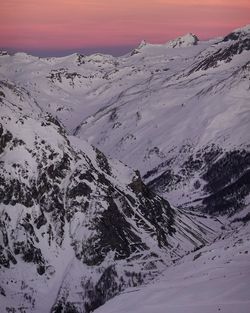 Scenic view of snow covered mountains against sky during sunset