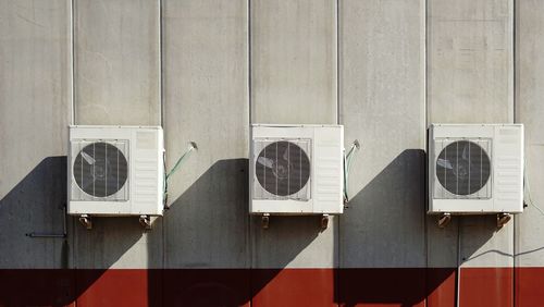 Close-up of coolers on wall