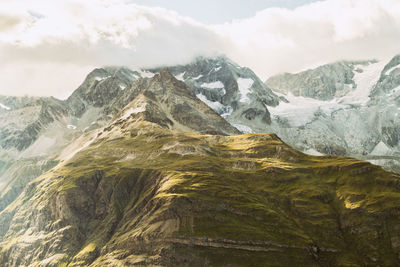 Scenic view of mountains against cloudy sky