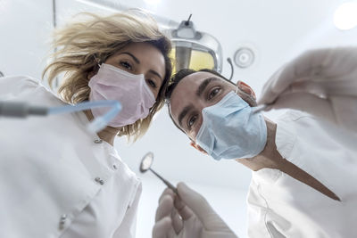 Portrait of doctor holding dentures