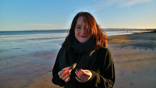 Portrait of beautiful young woman at beach