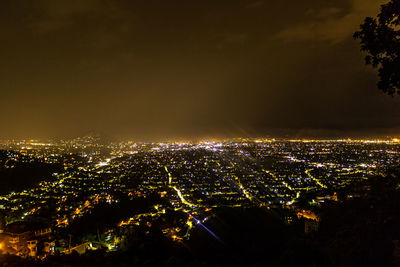 High angle view of illuminated buildings in city at night