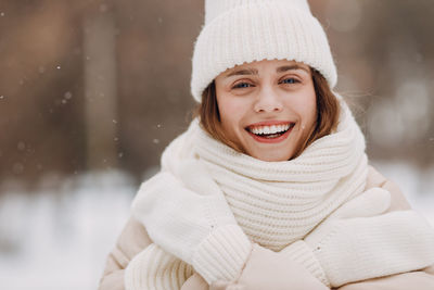 Portrait of young woman in warm clothing