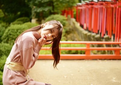 Side view of young woman standing outdoors