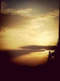 Silhouette landscape against sky at sunset