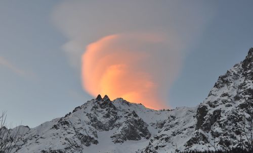 Scenic view of snowcapped mountains against sky during sunset