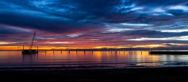 View of sea against cloudy sky during sunset
