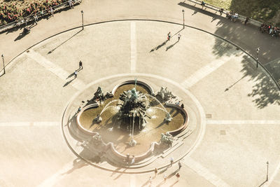 High angle view of people by fountain at park in city