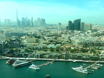Aerial view of buildings in city against sky