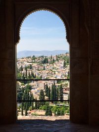 Cityscape seen through arch window in historic building