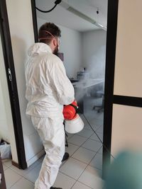 Rear view of man standing on floor