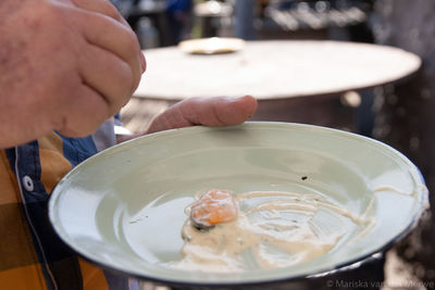 Close-up of person holding ice cream in bowl