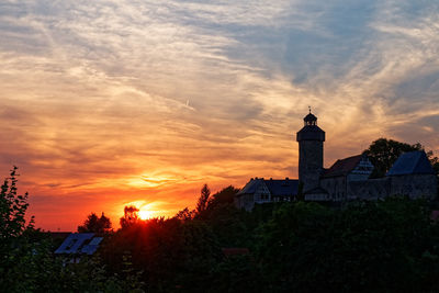 Silhouette buildings against sky during sunset