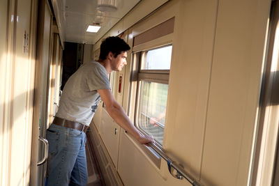 Man travels alone by train and looks out